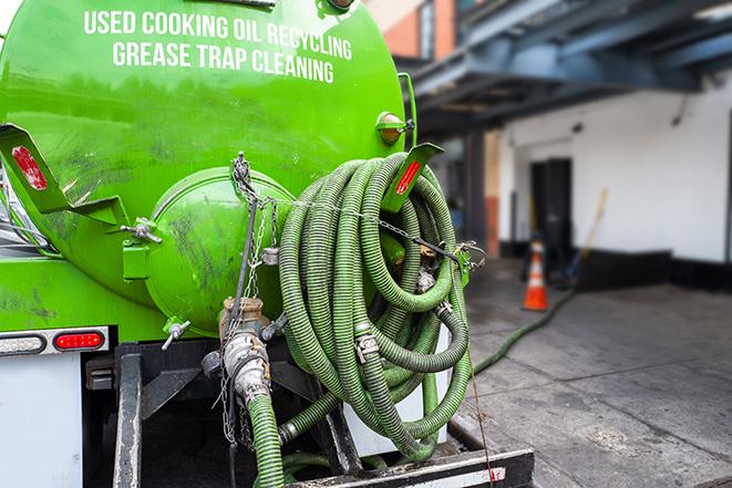 truck pumping out a large grease trap in Berkley, MI